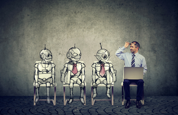 robots sitting with a man and laptop