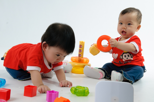two young children playing with toys